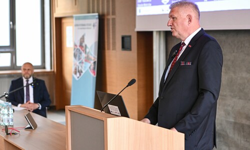 Wiceminister Zdrowia Wojciech Konieczny stoi przy m&oacute;wnicy, wygłaszając przem&oacute;wienie.